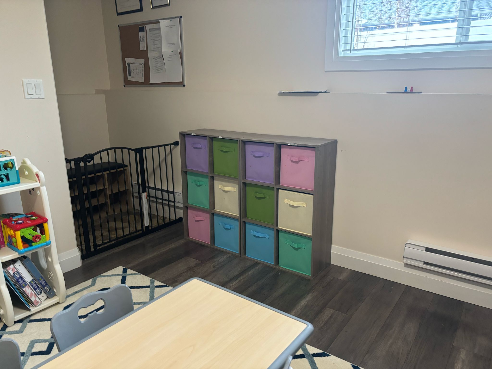 Bright Curious Minds classroom with colourful storage cubbies and child-size table