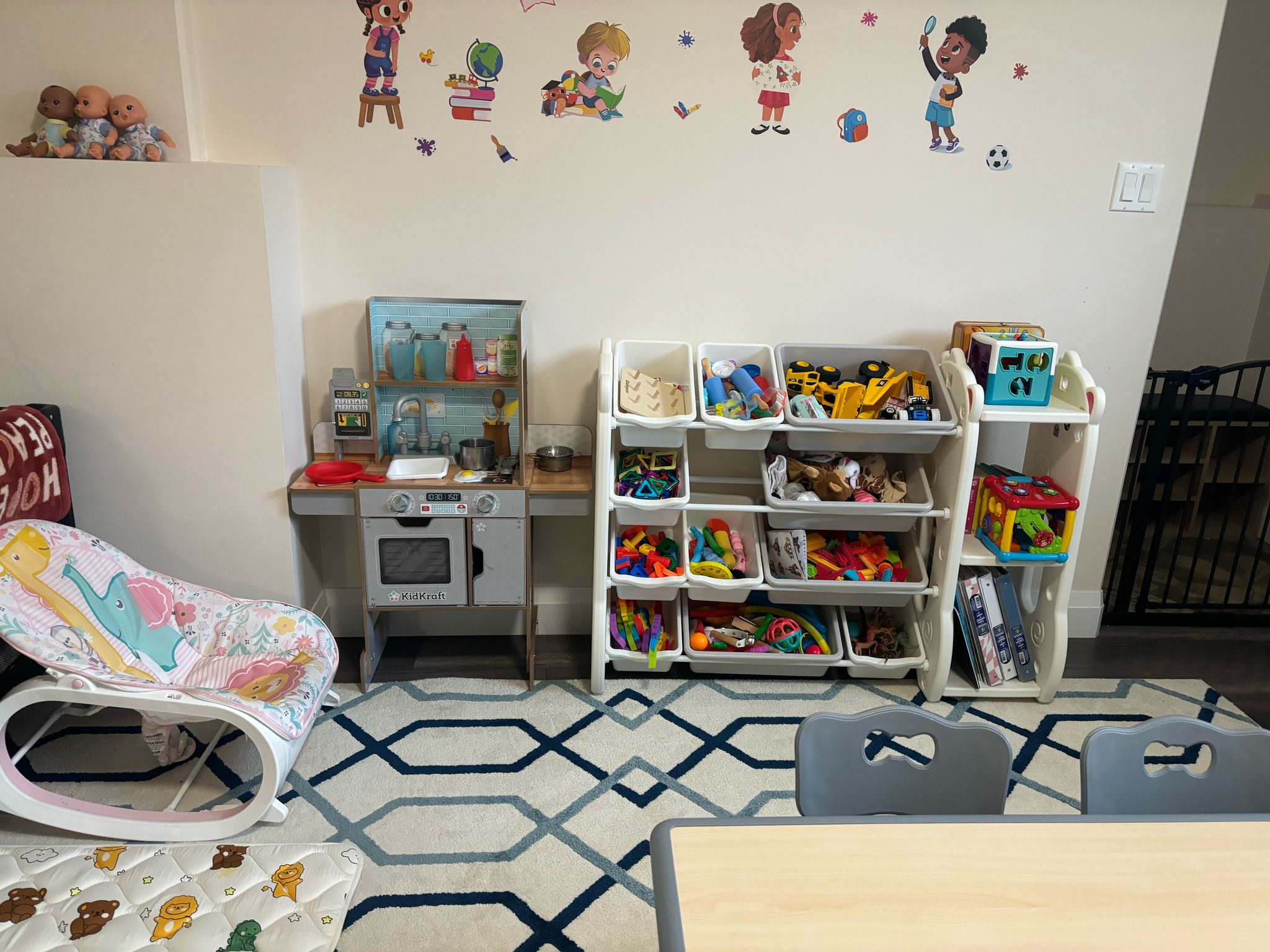 Toddler dramatic play area with KidKraft kitchen and toy organizer